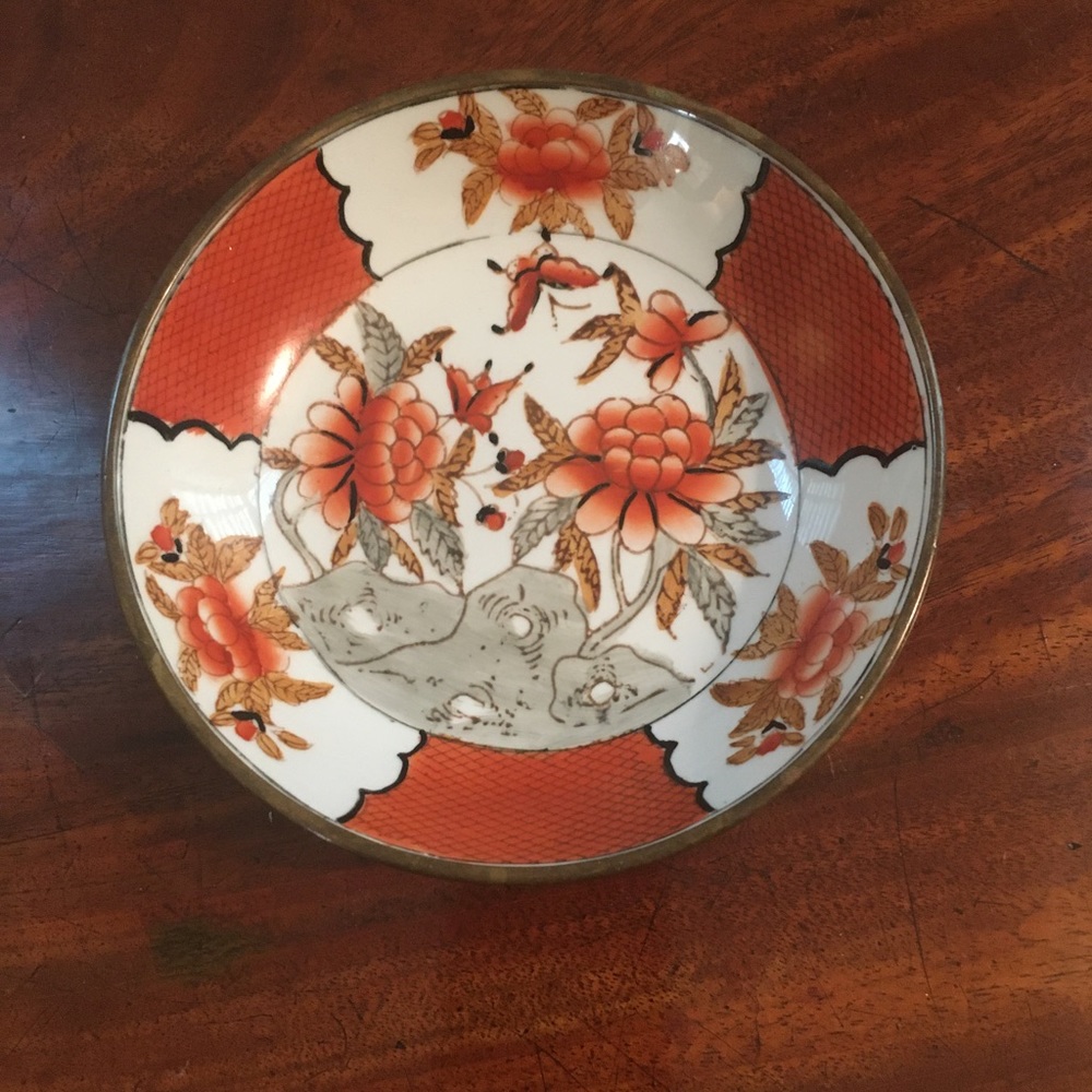 Small hand painted porcelain Asian bowl encased in brass